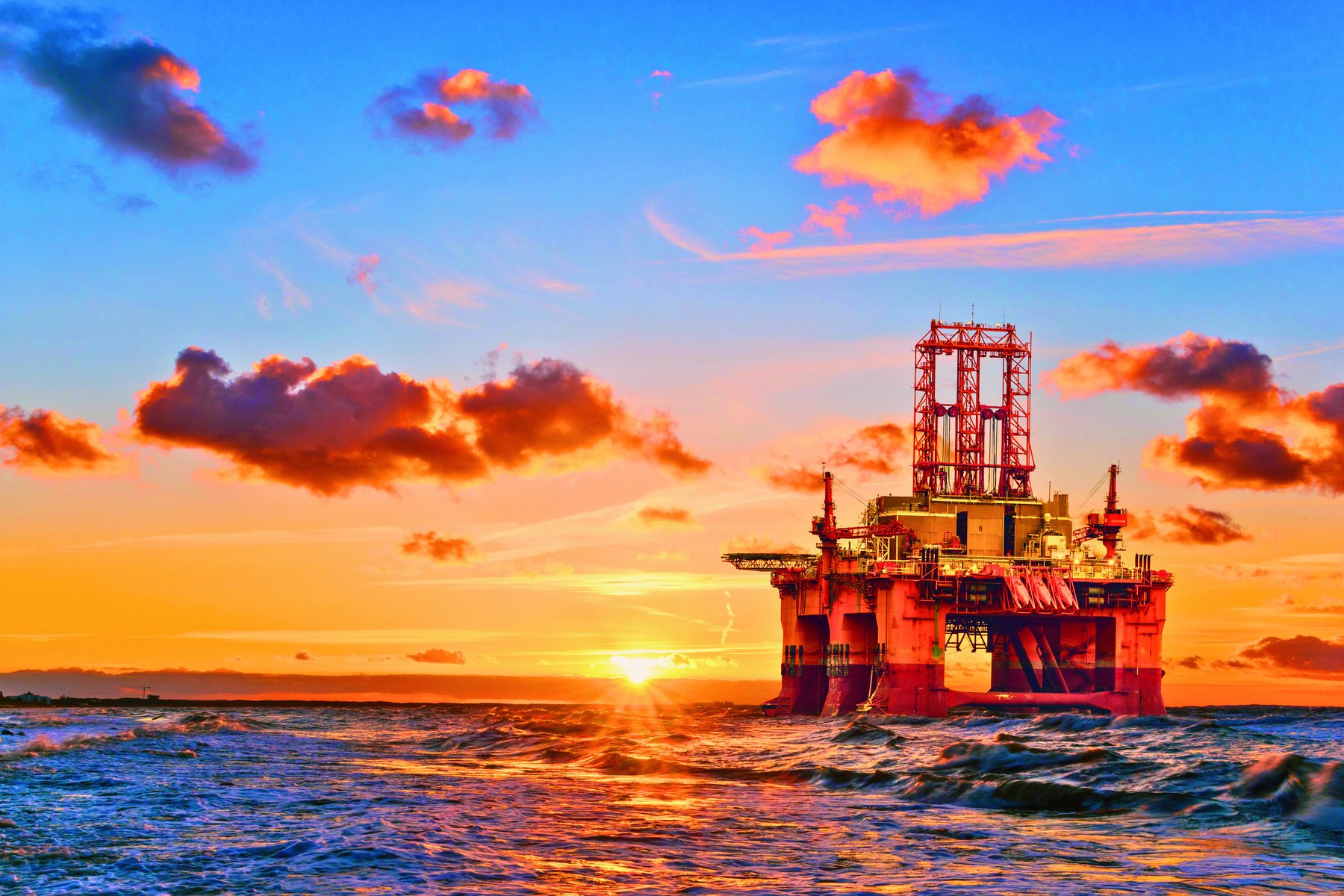 Offshore oil and gas platform at sunset — the high-risk environment Nabalu HF equipment is built for